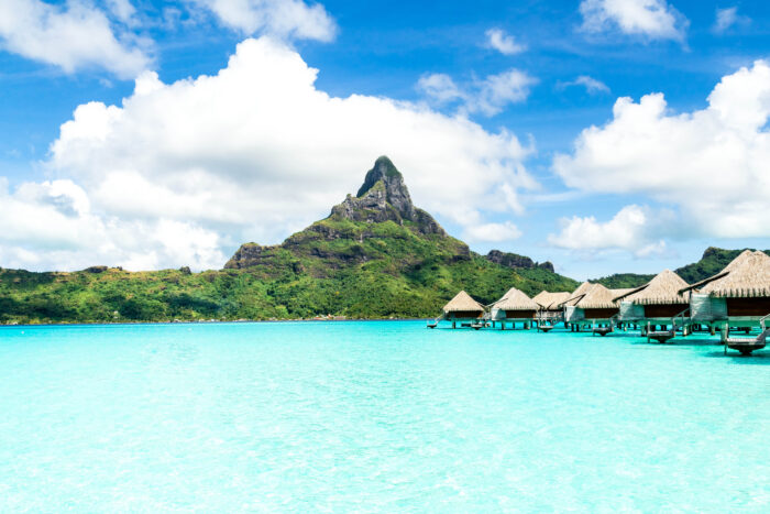 Türkisblaue Lagune mit Wasserbungalows und dem Berg Otemanu auf Bora Bora